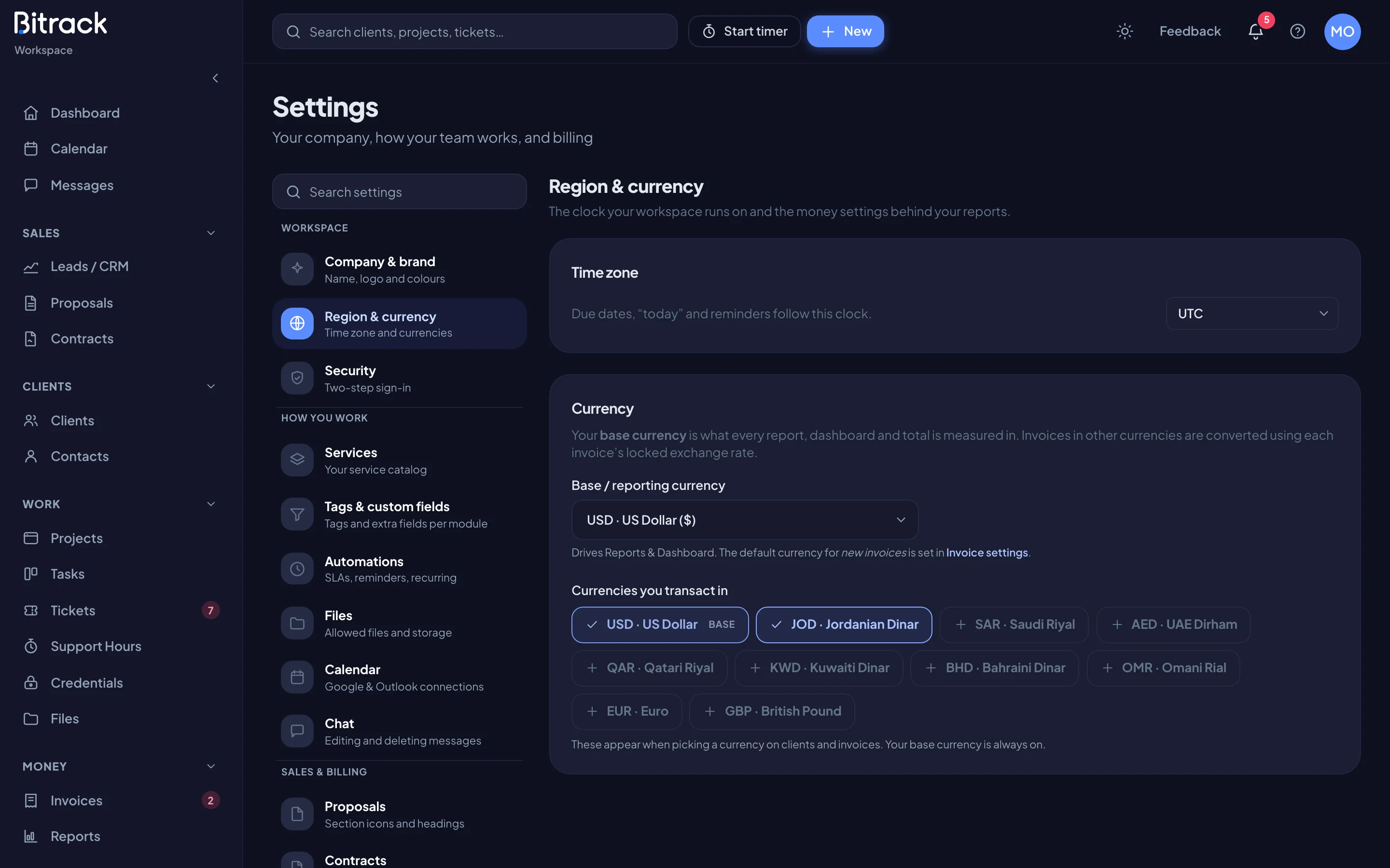 The Region & currency section with time zone and currency settings (dark mode)